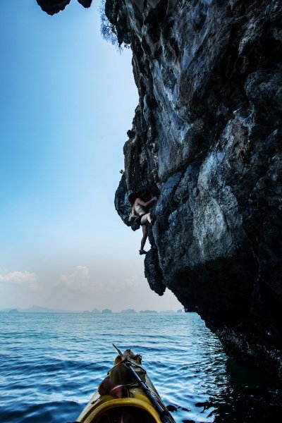 Abbey Smith climbs up wide tufas during a deep water solo trip to Lao Liang, Thailand