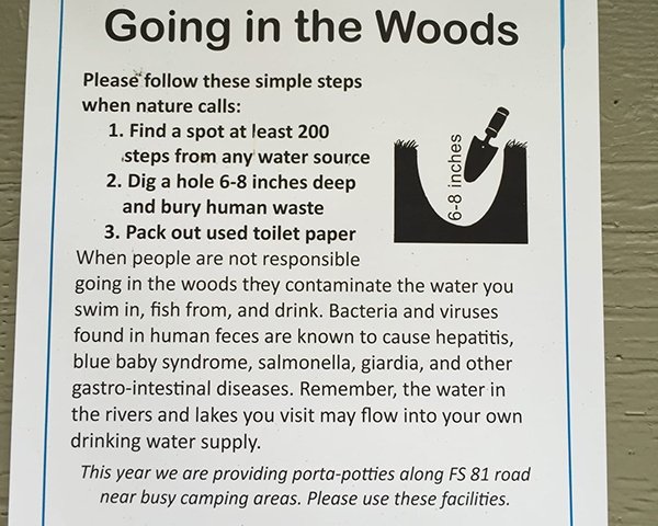 How to poop in the woods sign 