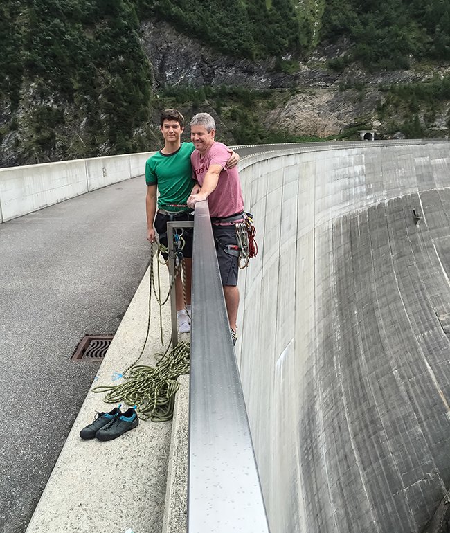 Kyle and Shane Murdoch top out at the guard rail finish line of Diga di Luzzone sport climb in Switzerland