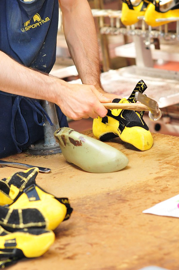 La Sportiva Miura VS construction is nearly done: the craftsman uses hand tools and coupled with a sense of feel earned by years of practice to finish the final adjustments on the shoe