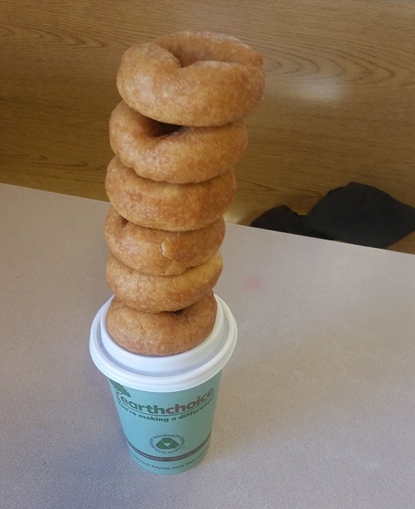 Stack of donuts on coffee cup 