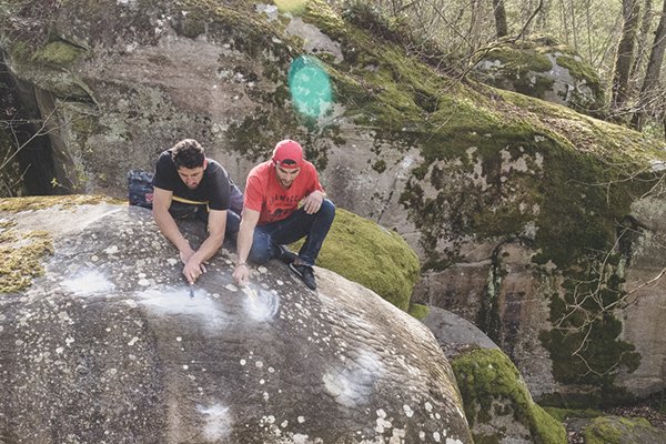 Jon Glassberg and friend cleaning boulder route