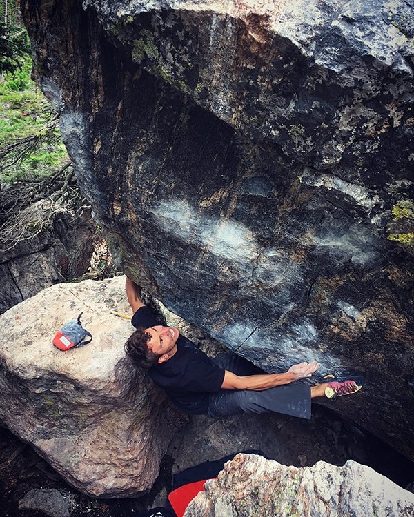 Jonathan Siegrist squeezing up the compression block "Storm Shadow Sit" (V12) in Colorado's RMNP