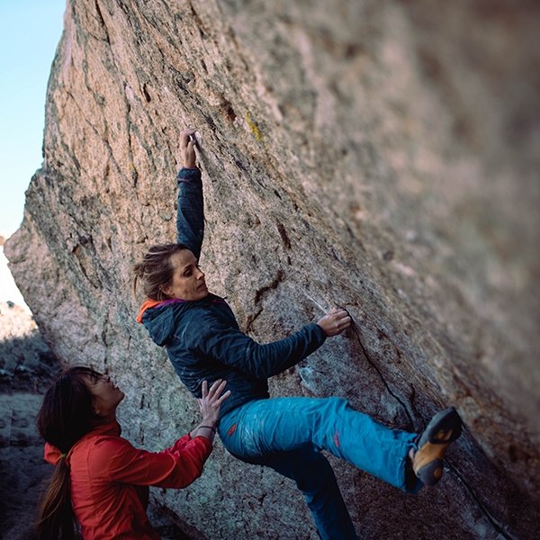 Lauren Callaway getting a power spot and support at the Women's Climbing Festival in Bishop.