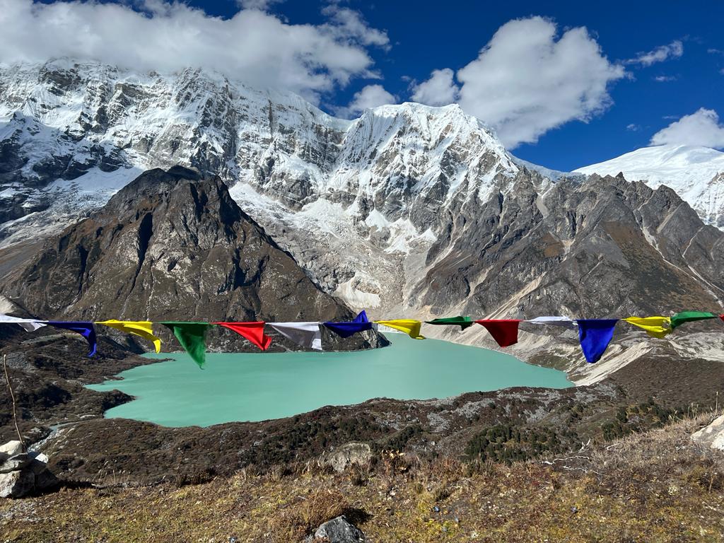Bright colorful tents on the edge of alpine lake, surrounded by beautiful mountain