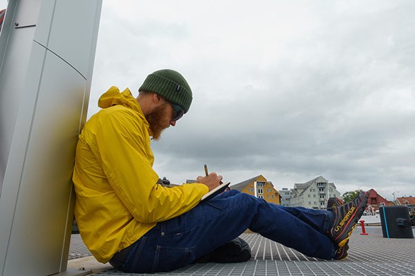 Luke Nelson journaling in Tromso, Norway