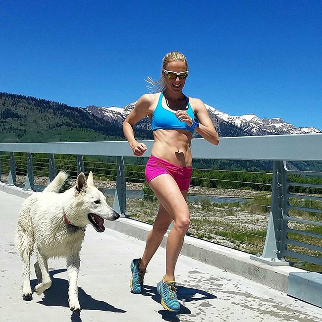 Meredith Edwards runs with a dog near Jackson, Wyoming during a speed workout