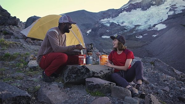 Two people camping and using the morsel spork