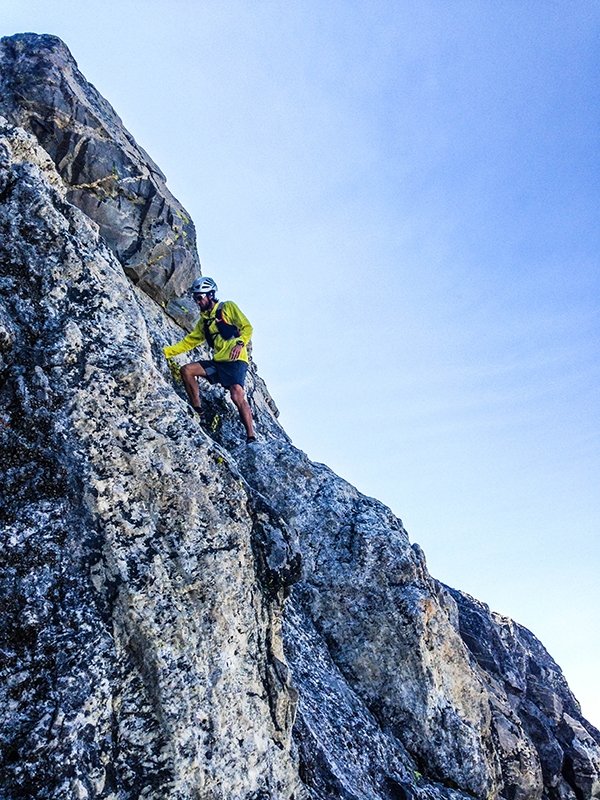 Nick Elson scrambling up the mountain 