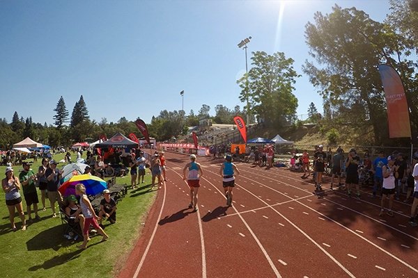 Sarah Keyes rounding the track at Placer High School