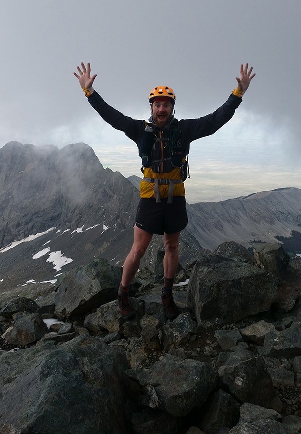 Justin Simoni posing on summit