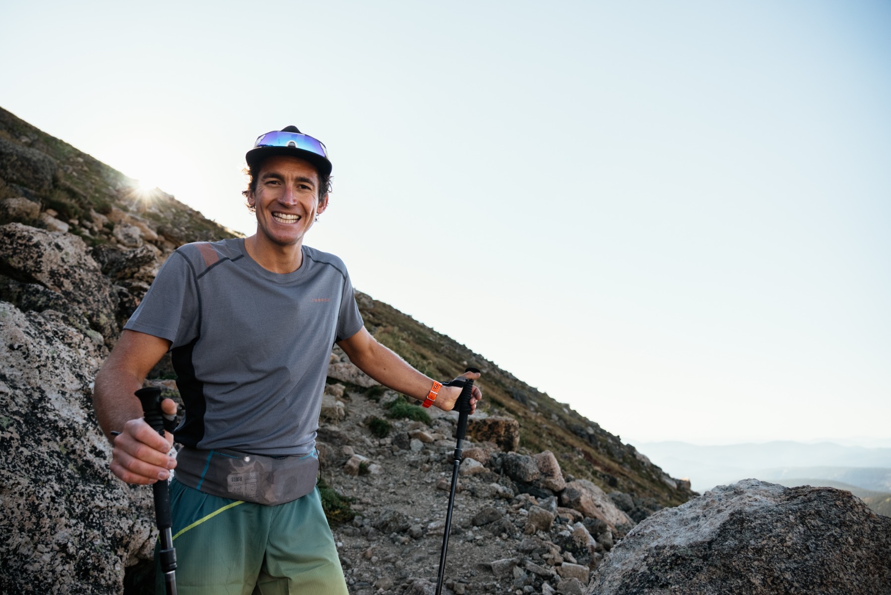 Davide smiling with trekking poles 